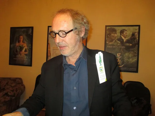 Arnaud Desplechin shows off Film4Climate bracelet from Anne-Katrin Titze